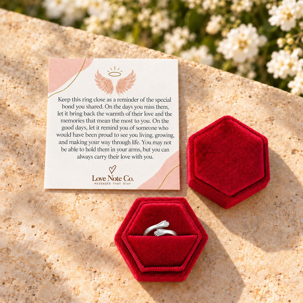 Hug From Heaven ring in its open gift box beside the card
