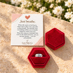 Just Breathe ring in its open gift box beside the card